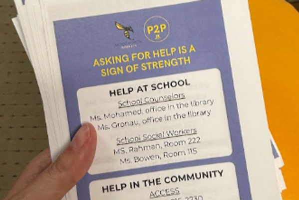 hand holding flyer with school and community resource info