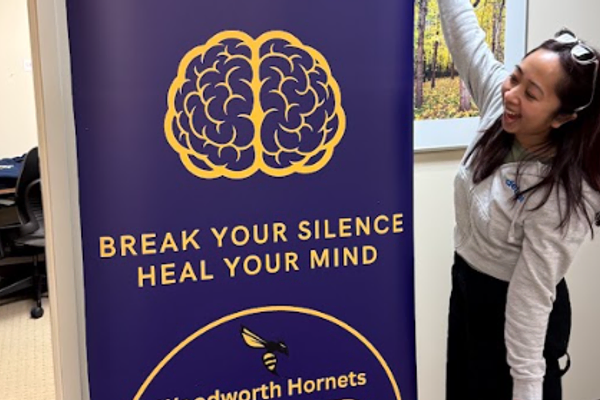 woman next to stand up display banner advertising P2P team
